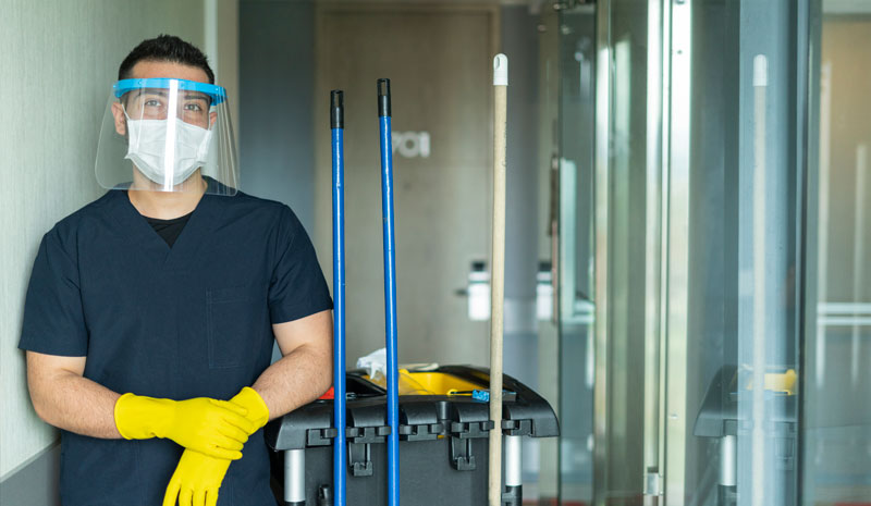 janitorial-services janitor with cleaning supplies